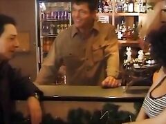Sexy customer in black stockings fucked by two guys in a bar